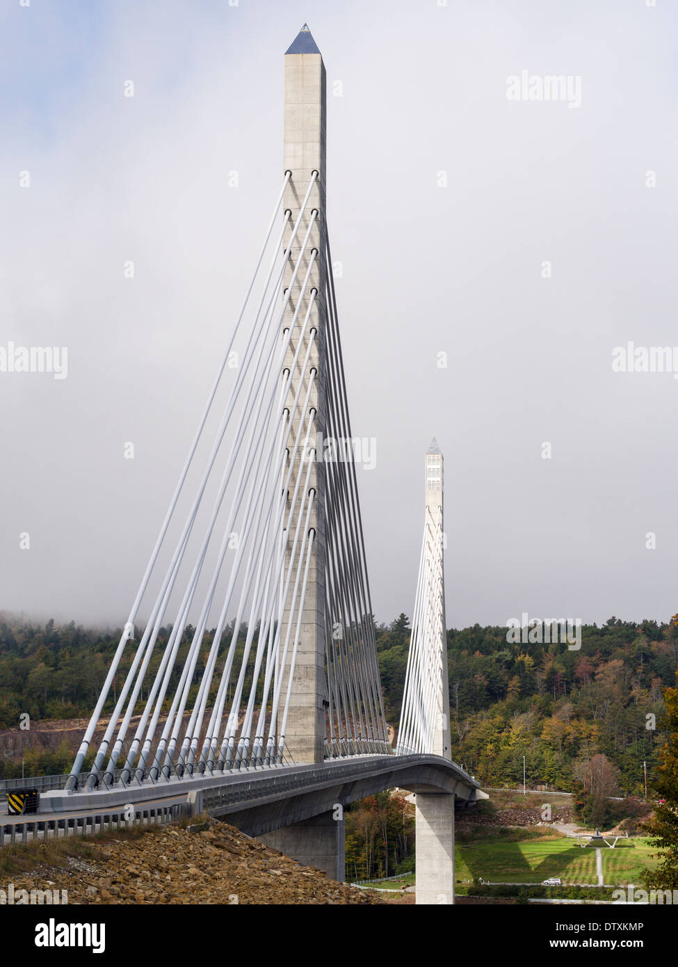 Penobscot Bridge early Fall. The twin towers of this iconic modern bridge rise above the wooded landscape lit by a weak sun Stock Photo