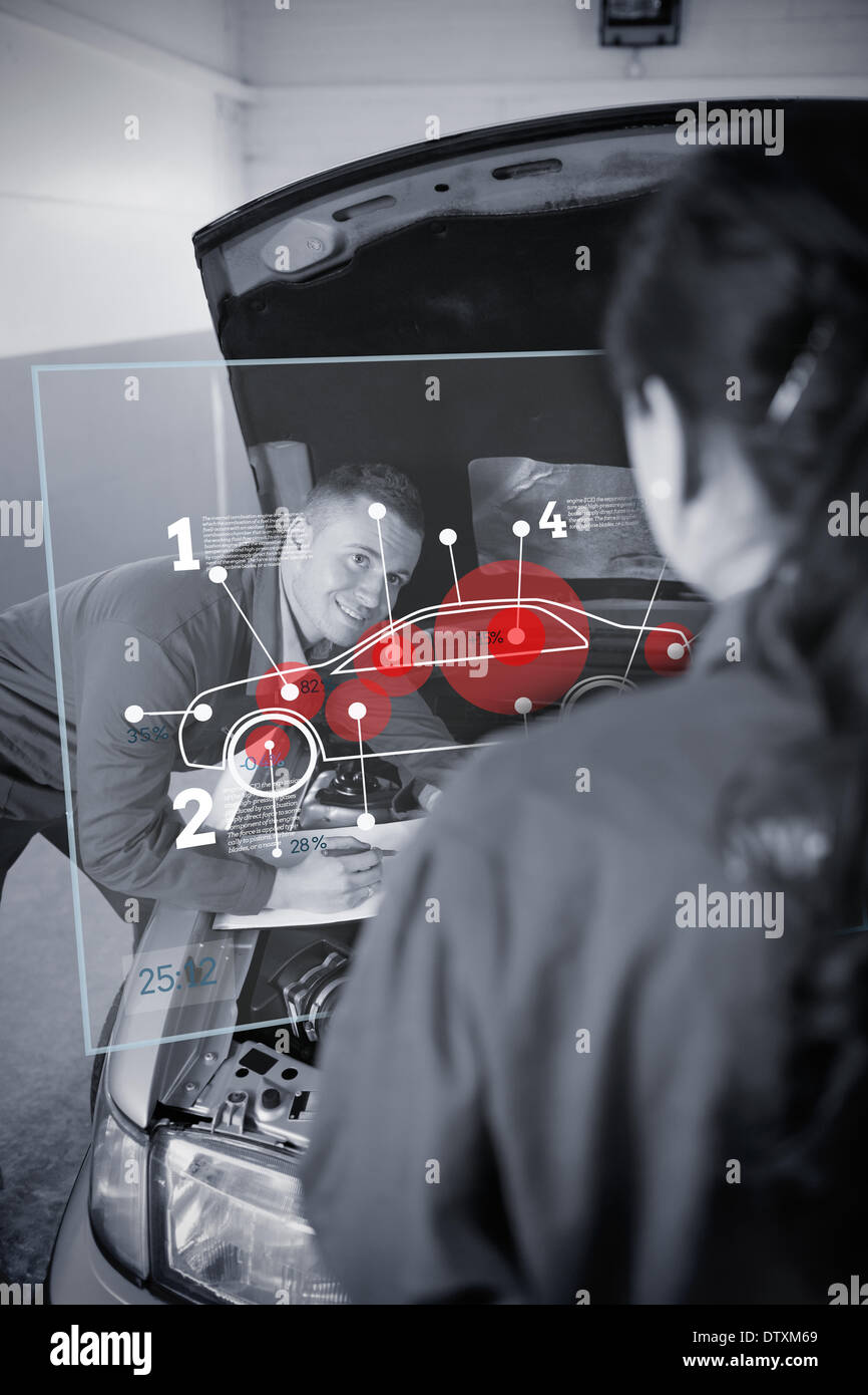 Two mechanics looking at futuristic interface Stock Photo