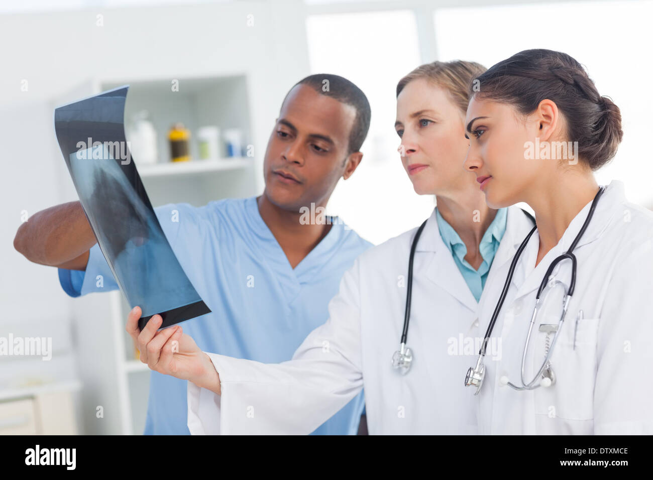 Medical team analysing an x-ray Stock Photo - Alamy