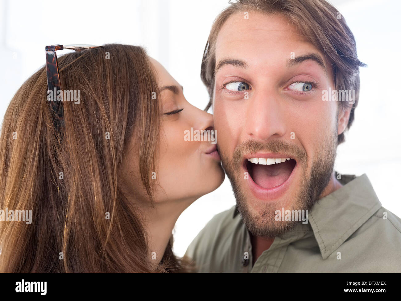 Woman kissing man with beard on the cheek Stock Photo Alamy