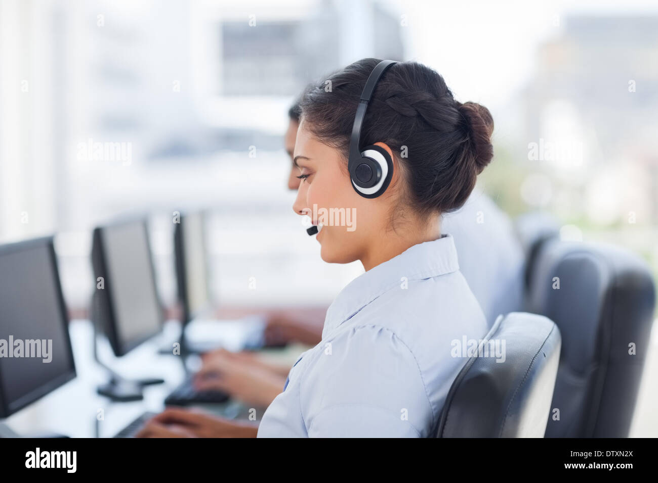 Attractive brunette working in a call centre Stock Photo