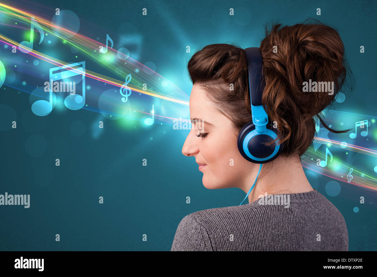 Young woman listening to music with headphones Stock Photo - Alamy