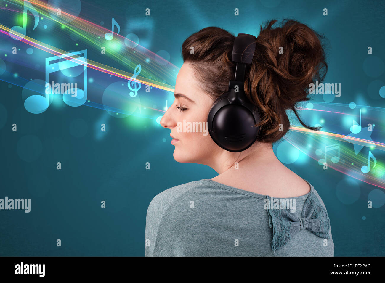 Young woman listening to music with headphones Stock Photo - Alamy