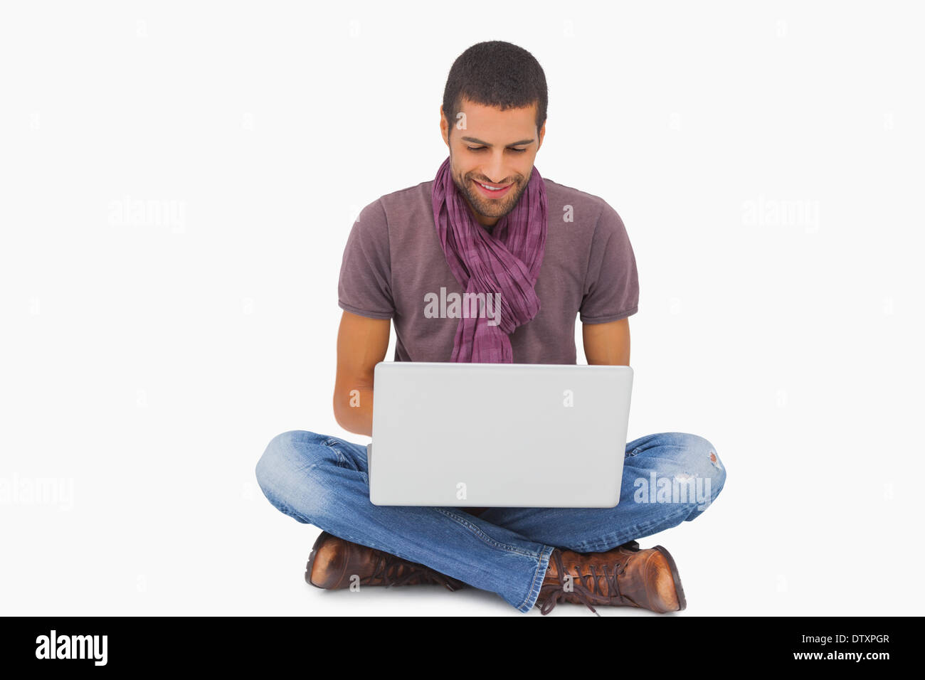Stylish man sitting on floor using laptop Stock Photo - Alamy