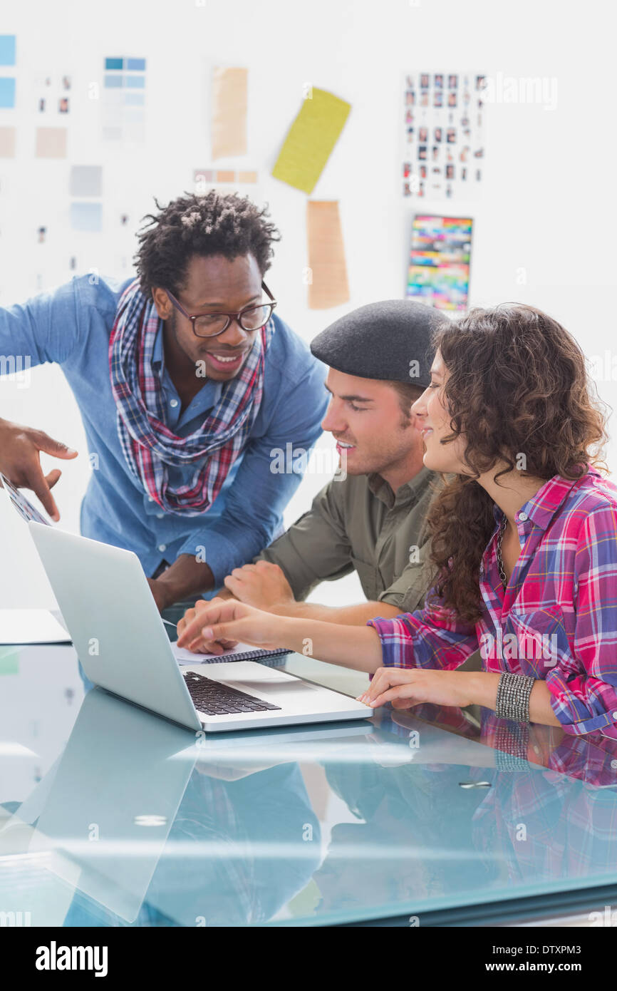Creative team working together on laptop Stock Photo - Alamy