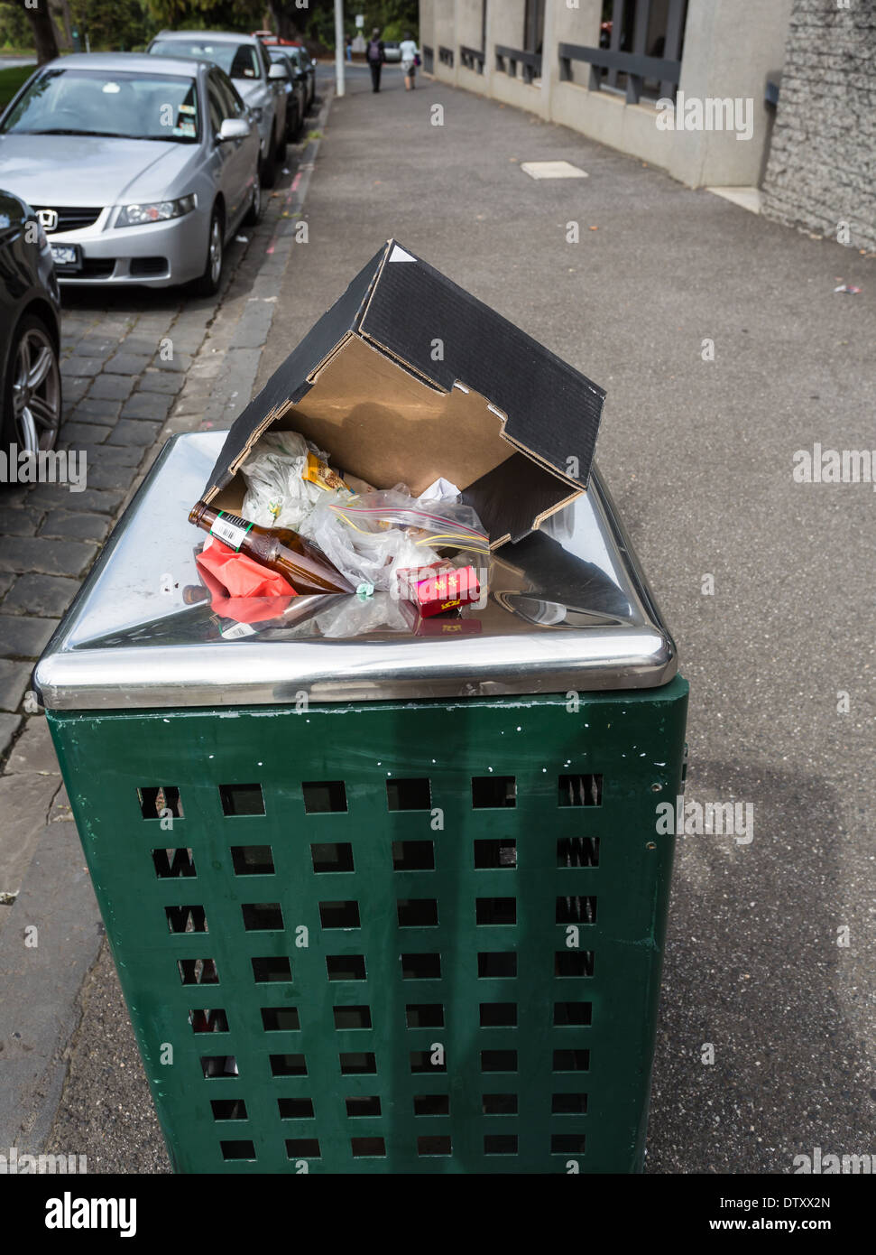 Public rubbish bin overflowing. Stock Photo