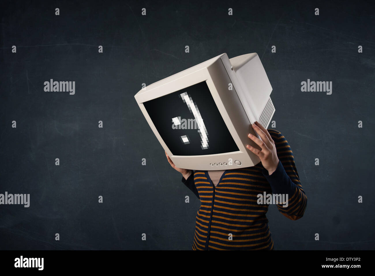 Funny girl with a monitor box on her head and a smiley face Stock Photo
