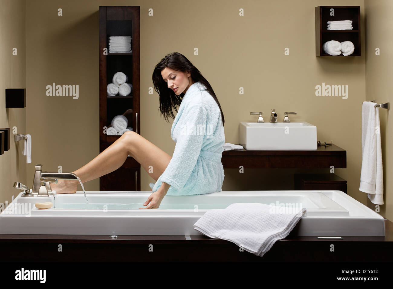 Caucasian woman running bath Stock Photo Alamy