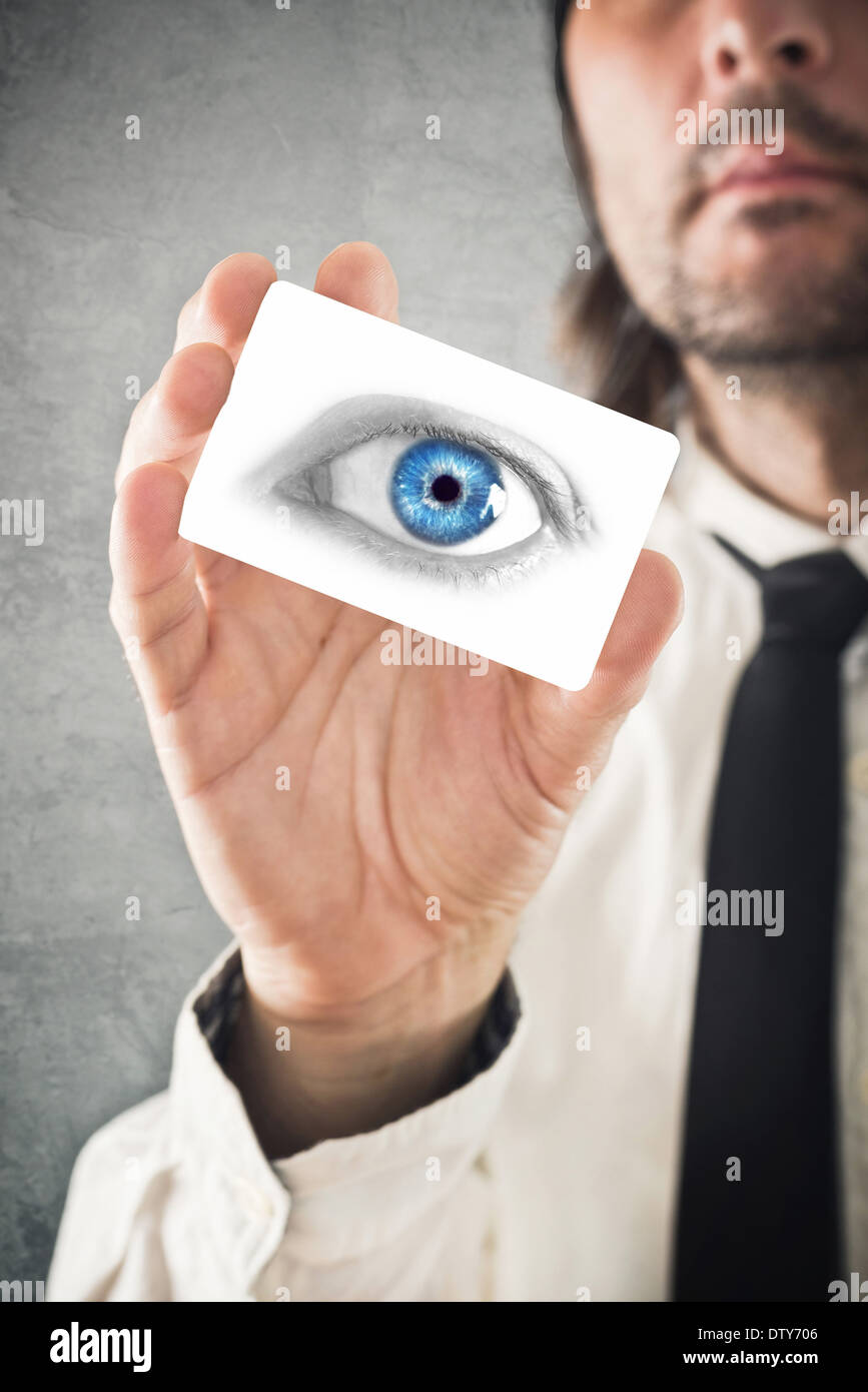 Ophthalmologist giving his visiting card, selective focus on fingers and card Stock Photo