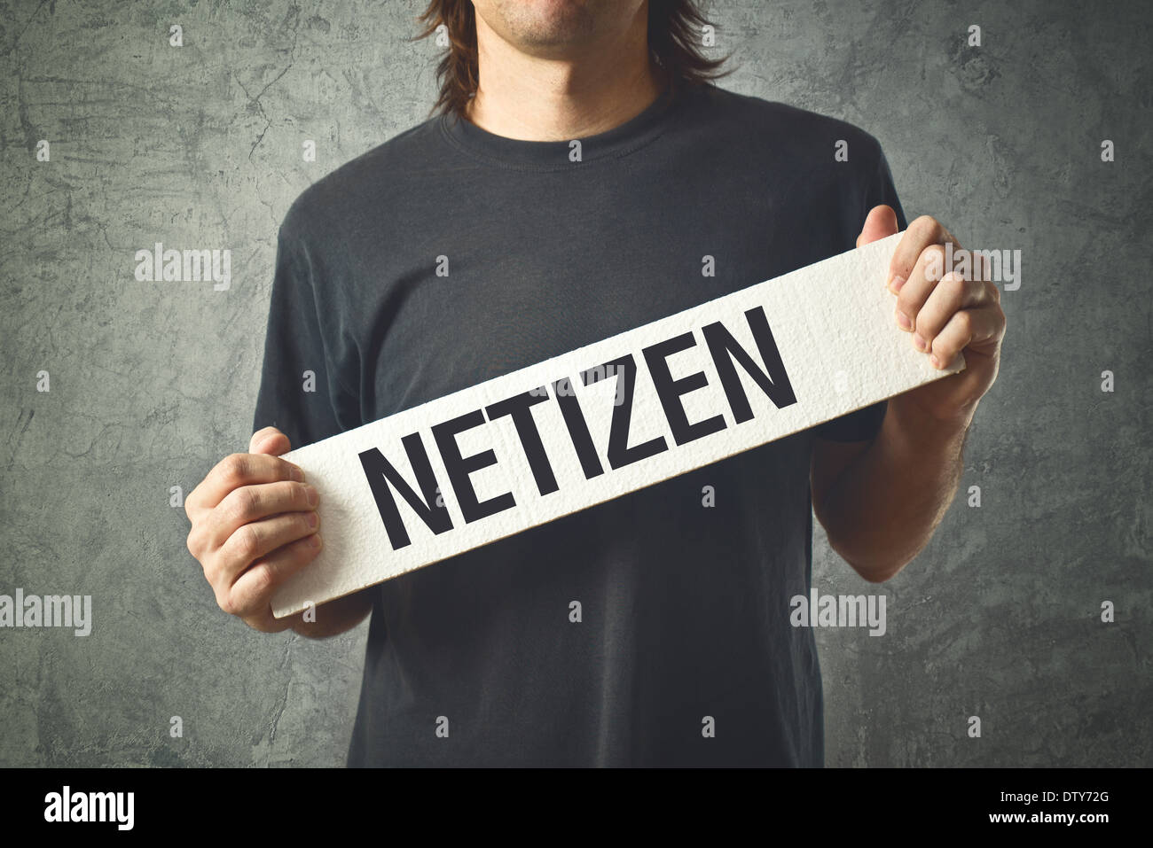 Man holding white banner with word NETIZEN printed. User of Internet and person actively involved in online communities. Stock Photo