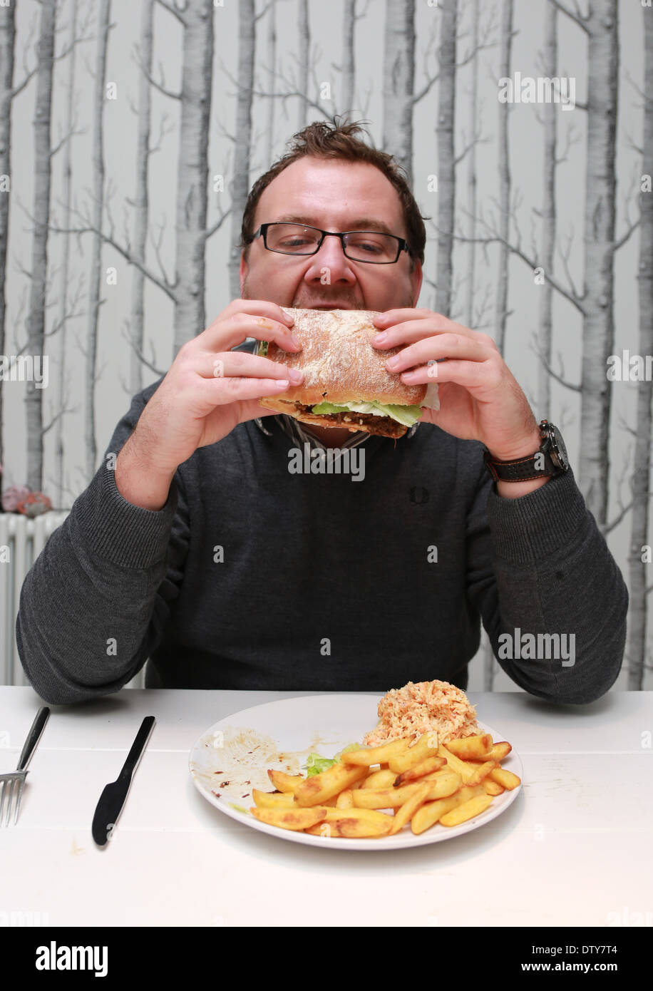 Person eating burger and chips hi-res stock photography and images - Alamy