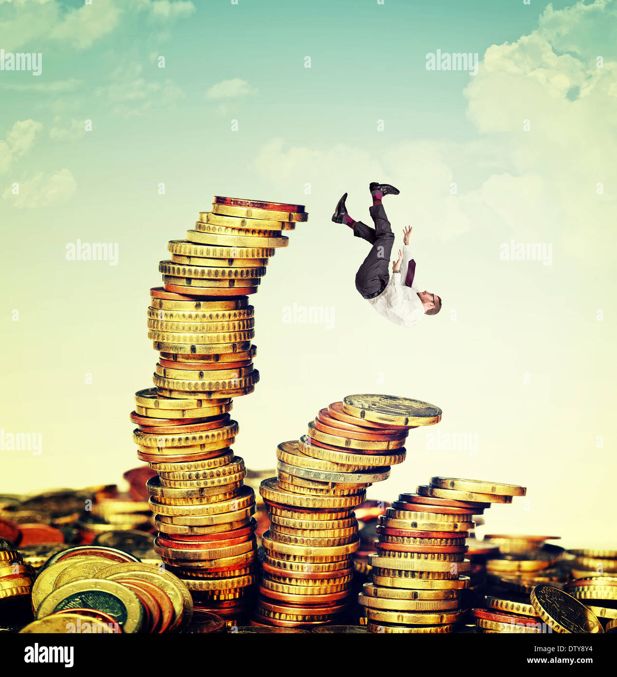 falling businessman and euro coin pile Stock Photo