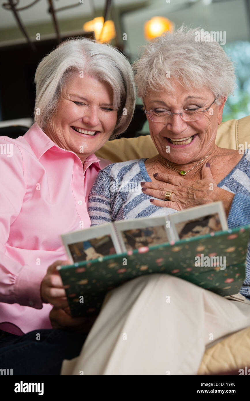 Two mature women looking at book hi-res stock photography and images ...