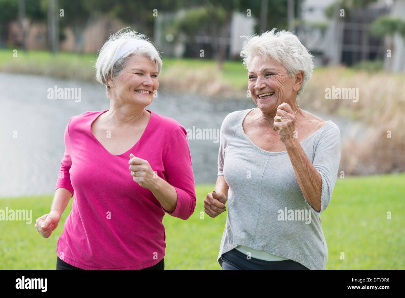 Senior Caucasian women jogging in park Stock Photo