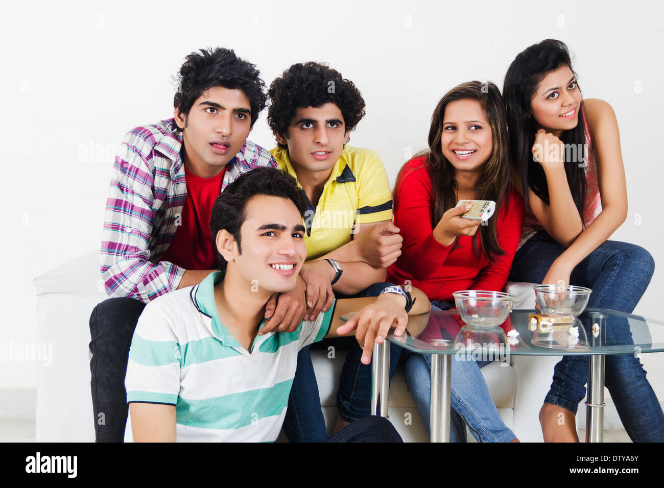 Indian friends watching tv hi-res stock photography and images - Alamy