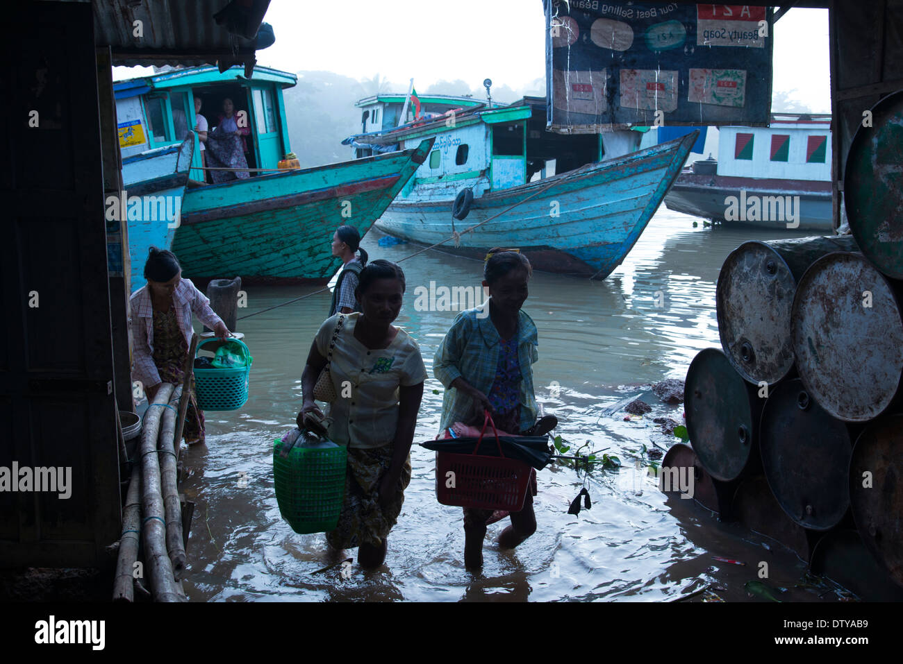 Passengers disembarking from passenger boats. Myaung Mya harbour. Irrawaddyi ivision. Myanmar (Burma). Stock Photo