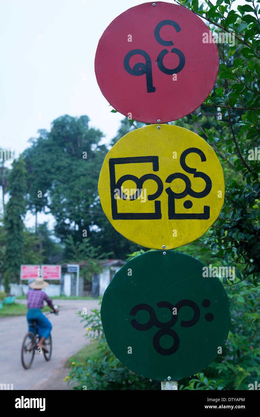 Road safety sign in the form of a traffic light. Myaung Mya. Myanmar (Burma). Stock Photo