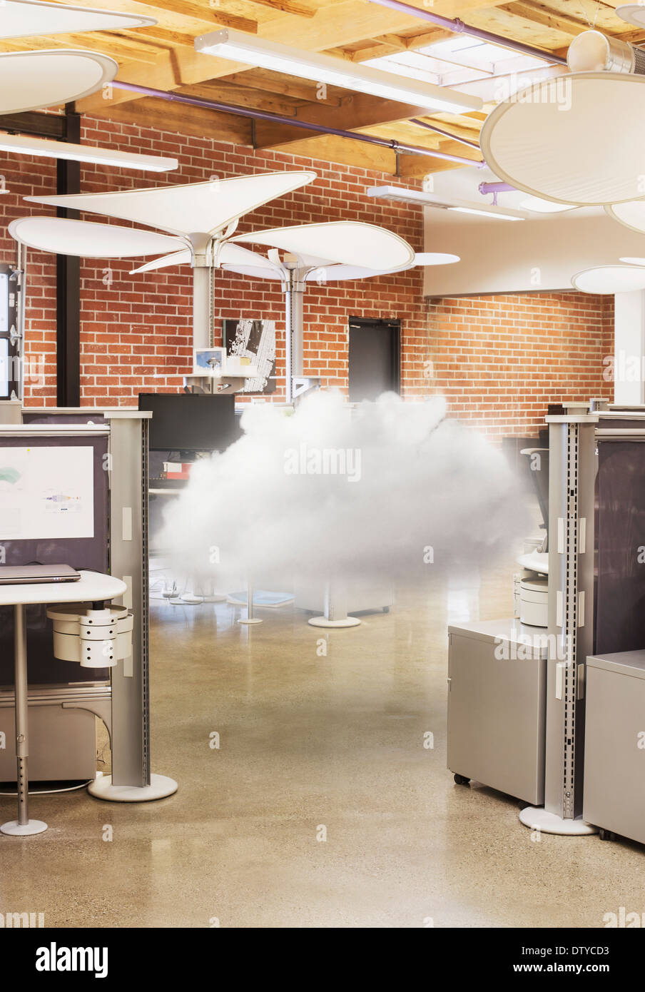 Cloud hovering in modern office Stock Photo
