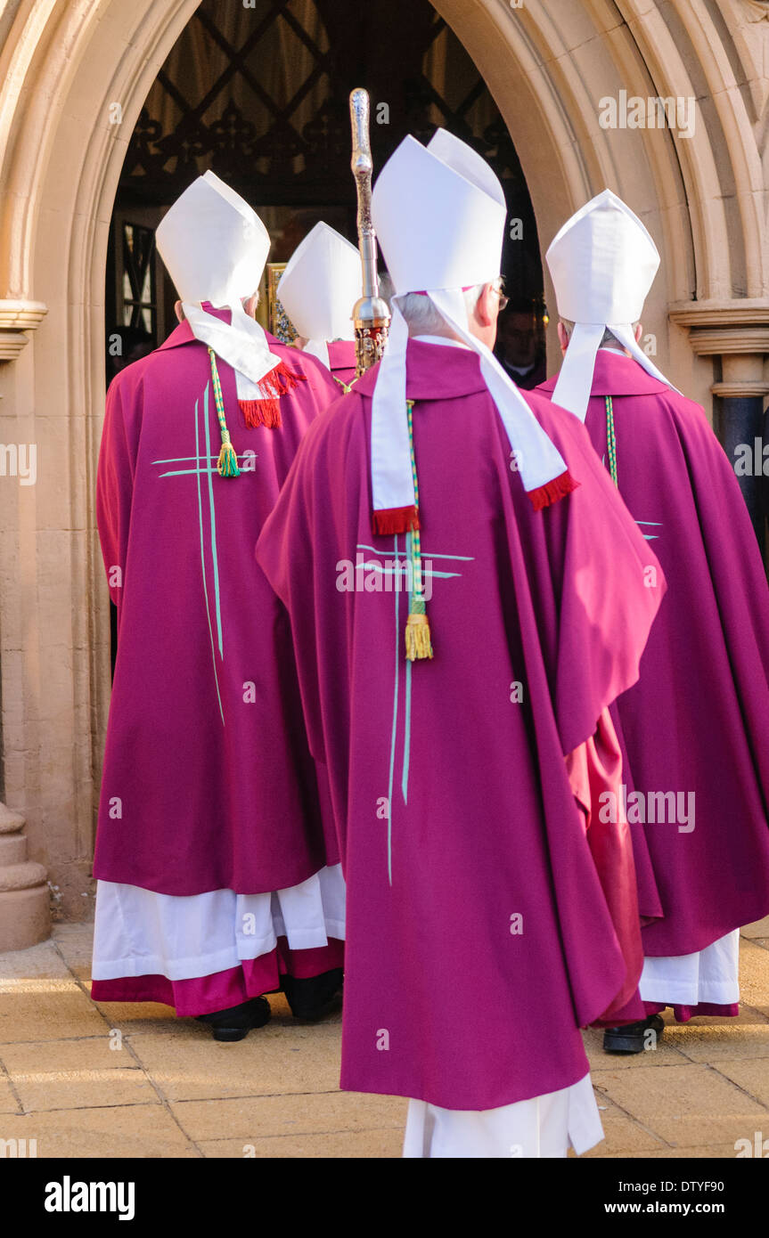 Four bishops enter a church dressed in ceremonial robes Stock Photo