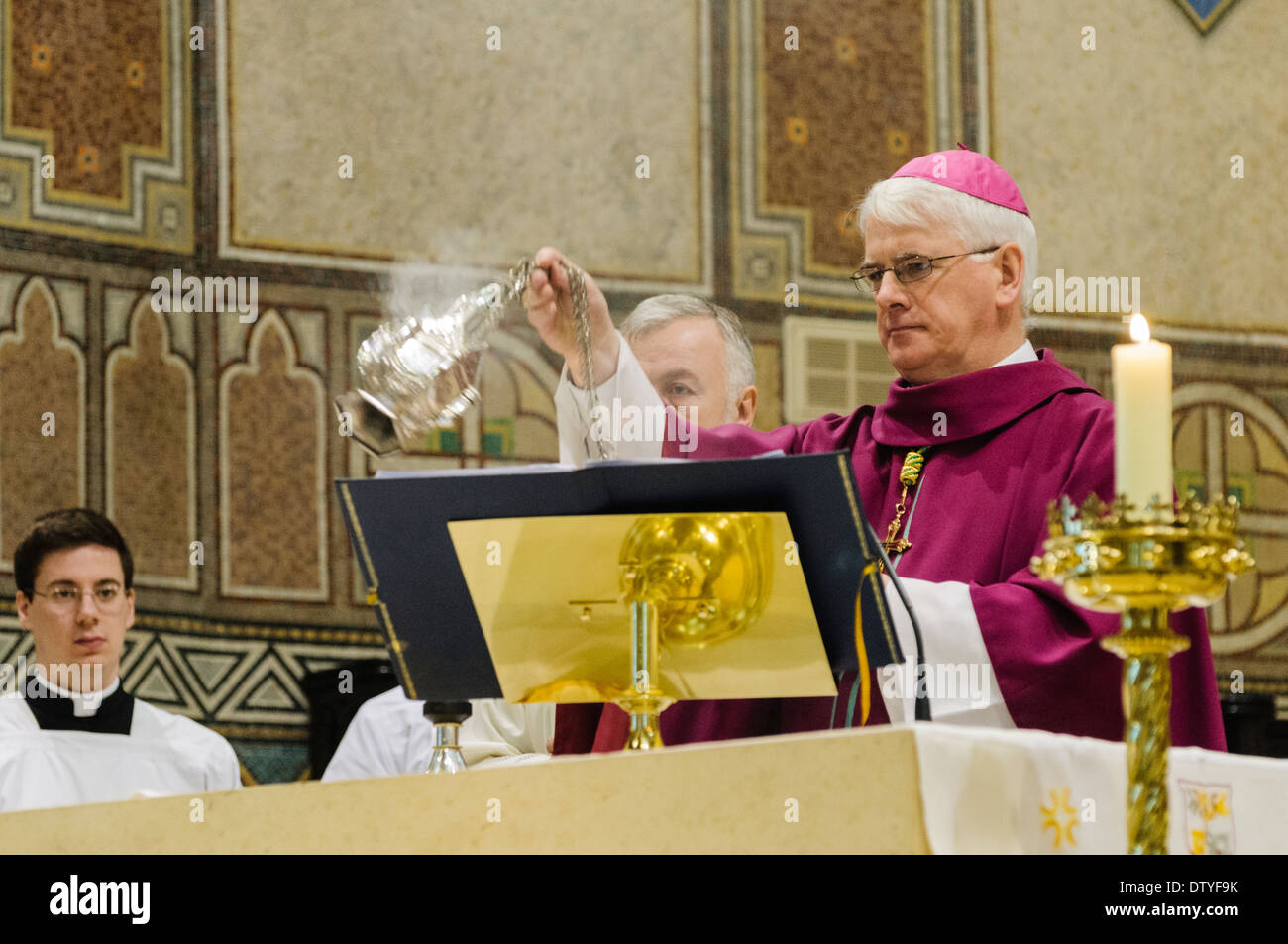 Noel Treanor swings an incense urn during a mass Stock Photo Alamy