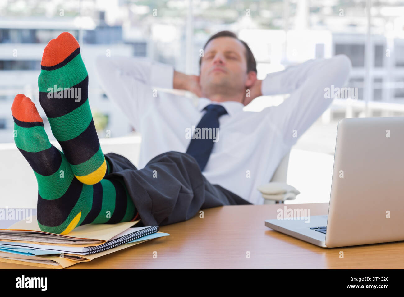 Businessman sleeping with feet on his desk Stock Photo Alamy