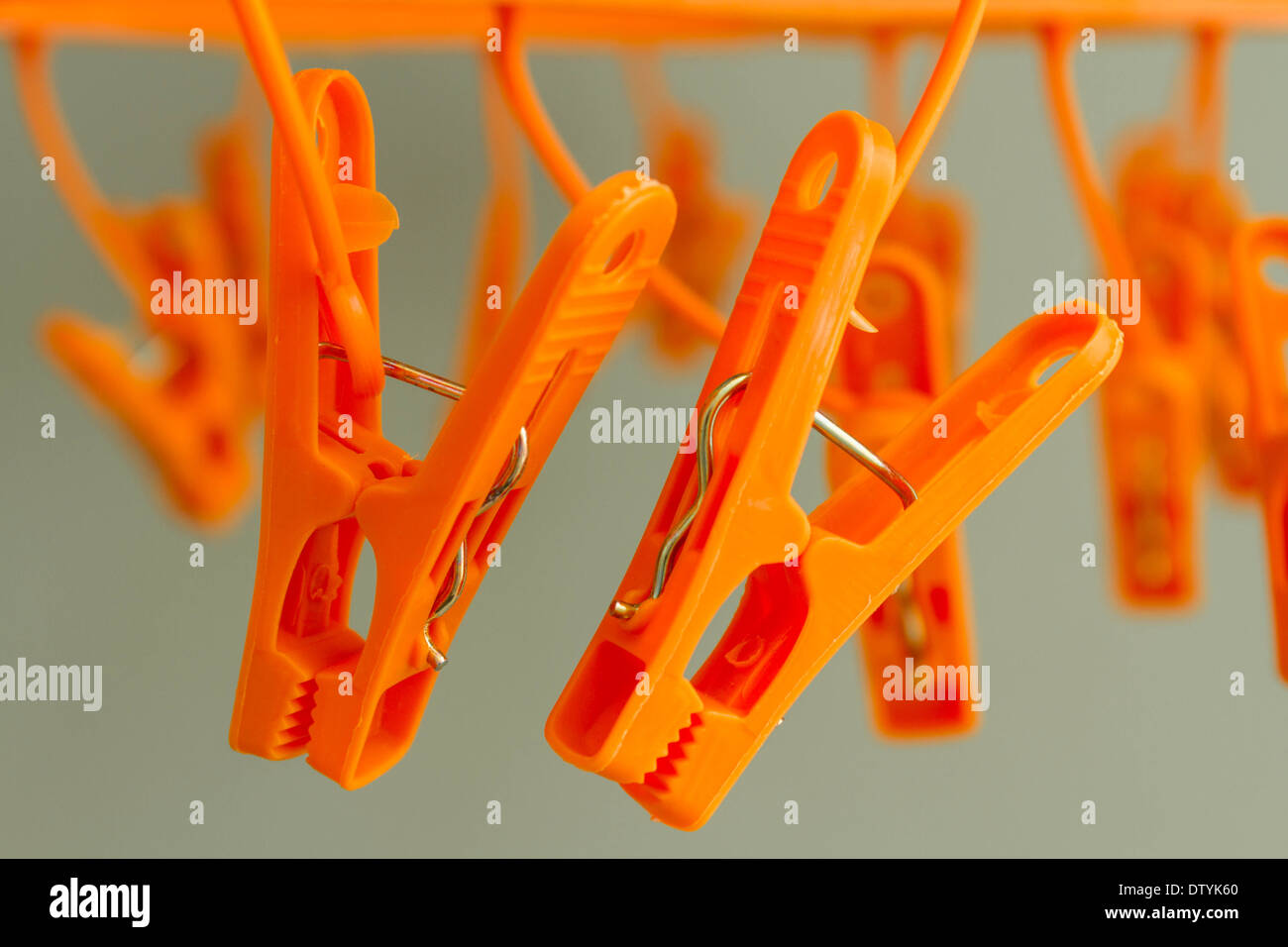 Orange color clothespins in coat hanger Stock Photo