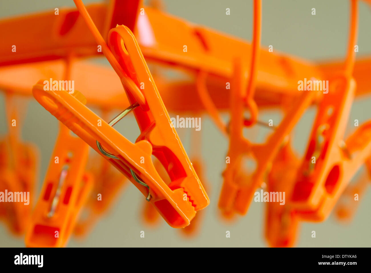 Orange color clothespins in coat hanger Stock Photo