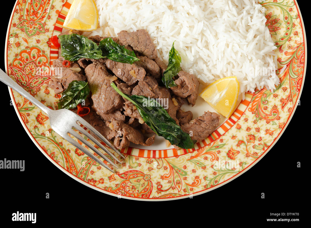 Chilli beef with crispy fried basil leaves, served with white basmati
