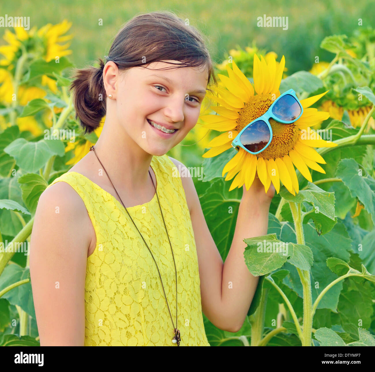 Portrait of a beautiful young Teenage on sunflower field Stock Photo ...