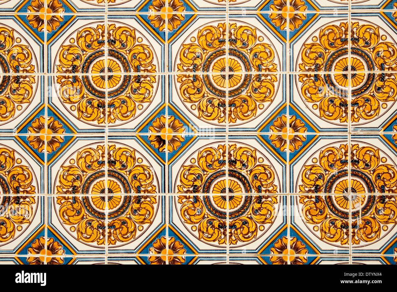 gold and blue patterned ceramic tiles on an external wall in Portugal Stock Photo