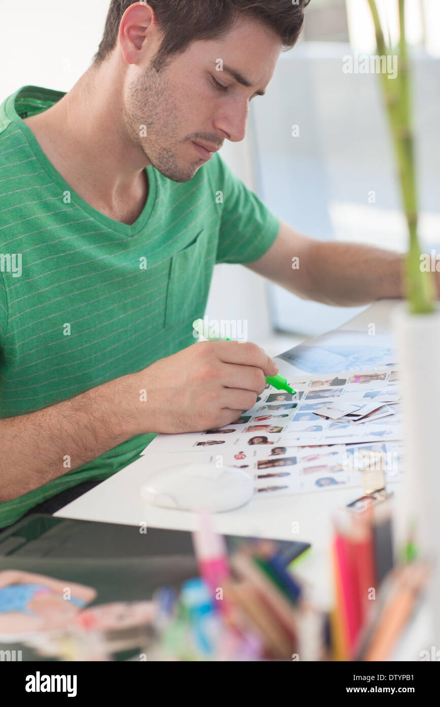 Photo editor working on a contact sheet Stock Photo - Alamy