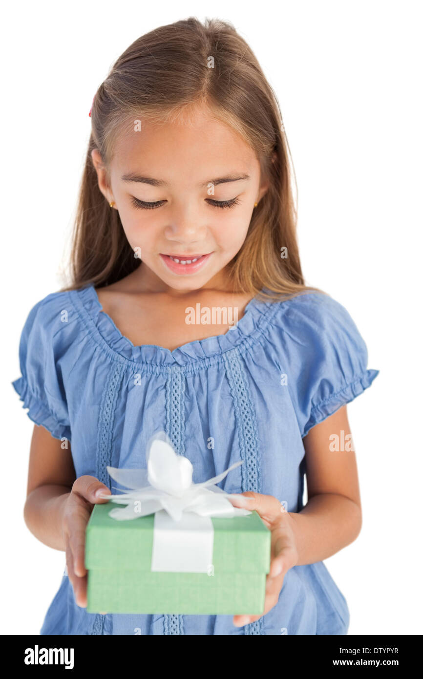 Cute little girl holding a wrapped gift Stock Photo - Alamy