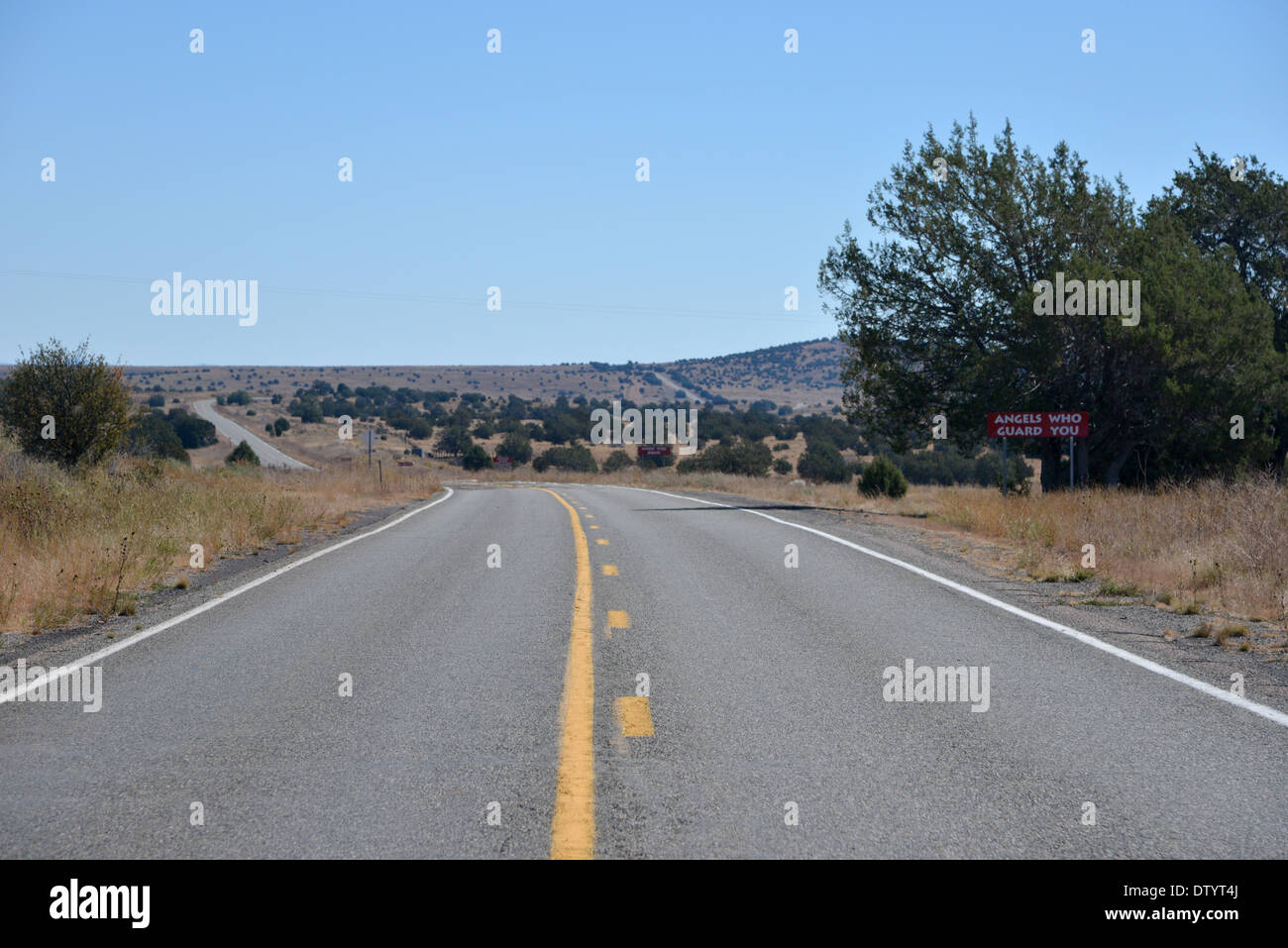 Burma Shave signs on Route 66, USA. Long road disappears into the distance under a lonely blue sky Stock Photo