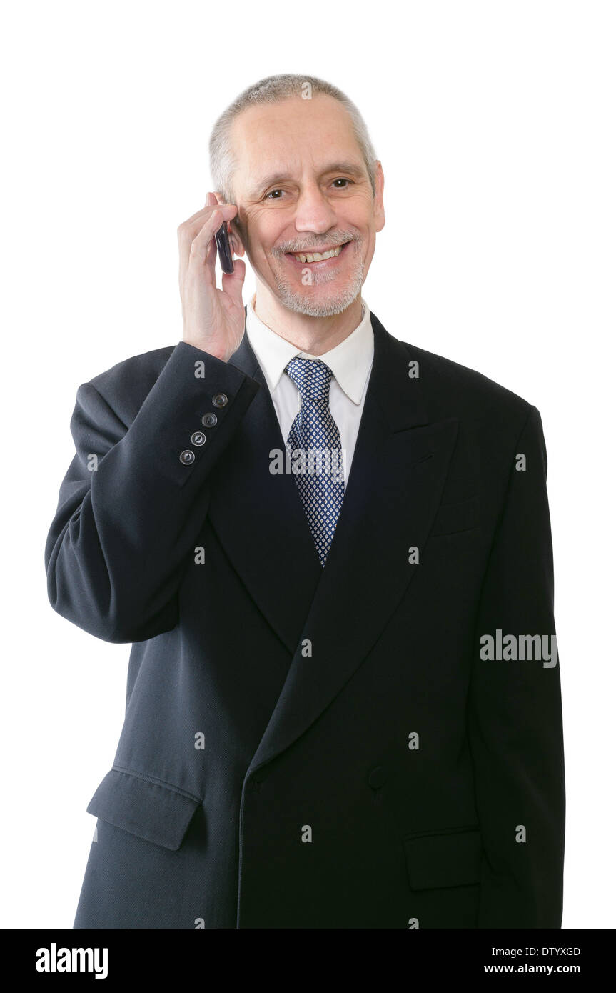 An amicable businessman smiling on mobile phone Stock Photo