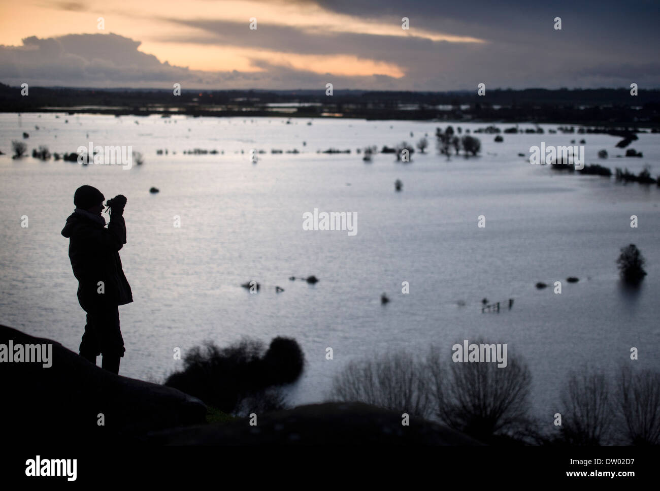Flooding on the Somerset Levels - a bird watcher views the levels from Burrow Mump Feb 2014 Stock Photo