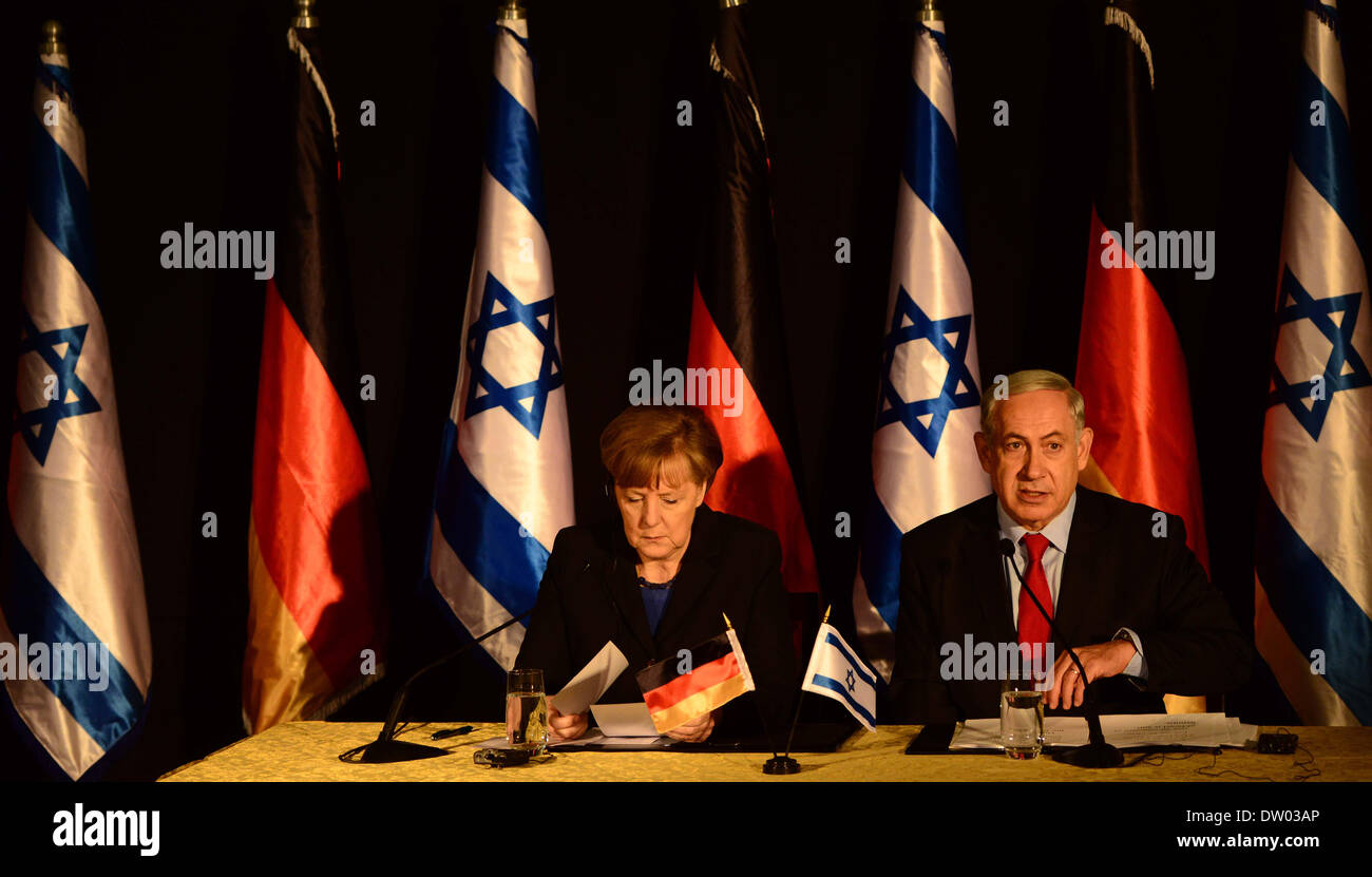 Jerusalem, Jerusalem, Palestinian Territory. 25th Feb, 2014. German Chancellor Angela Merkel (L) listens as Israeli Prime Minister Benjamin Netanyahu speaks during a joint press conference after their cabinets held a meeting at the King David hotel in Jerusalem on February 25, 2014. Merkel arrived in Israel with her cabinet yesterday to discuss nuclear talks with Iran and to encourage Prime Minister Netanyahu to reach a two-state solution with the Palestinians Credit:  Saeed Qaq/APA Images/ZUMAPRESS.com/Alamy Live News Stock Photo