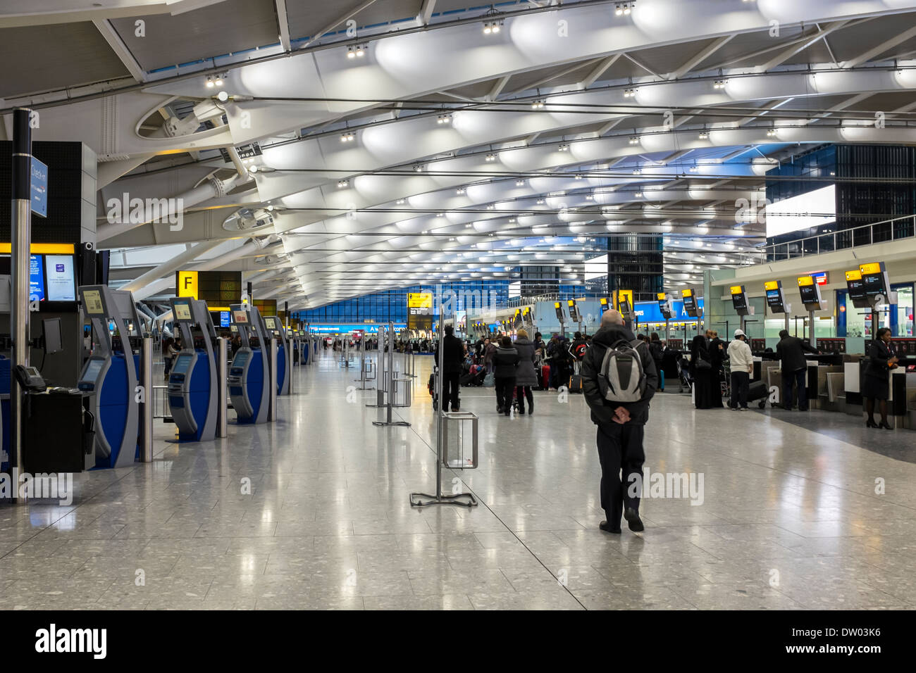 Check in booths and luggage drop off counters in departure hall at Terminal 5 T5, Heathrow Airport, London, UK Stock Photo