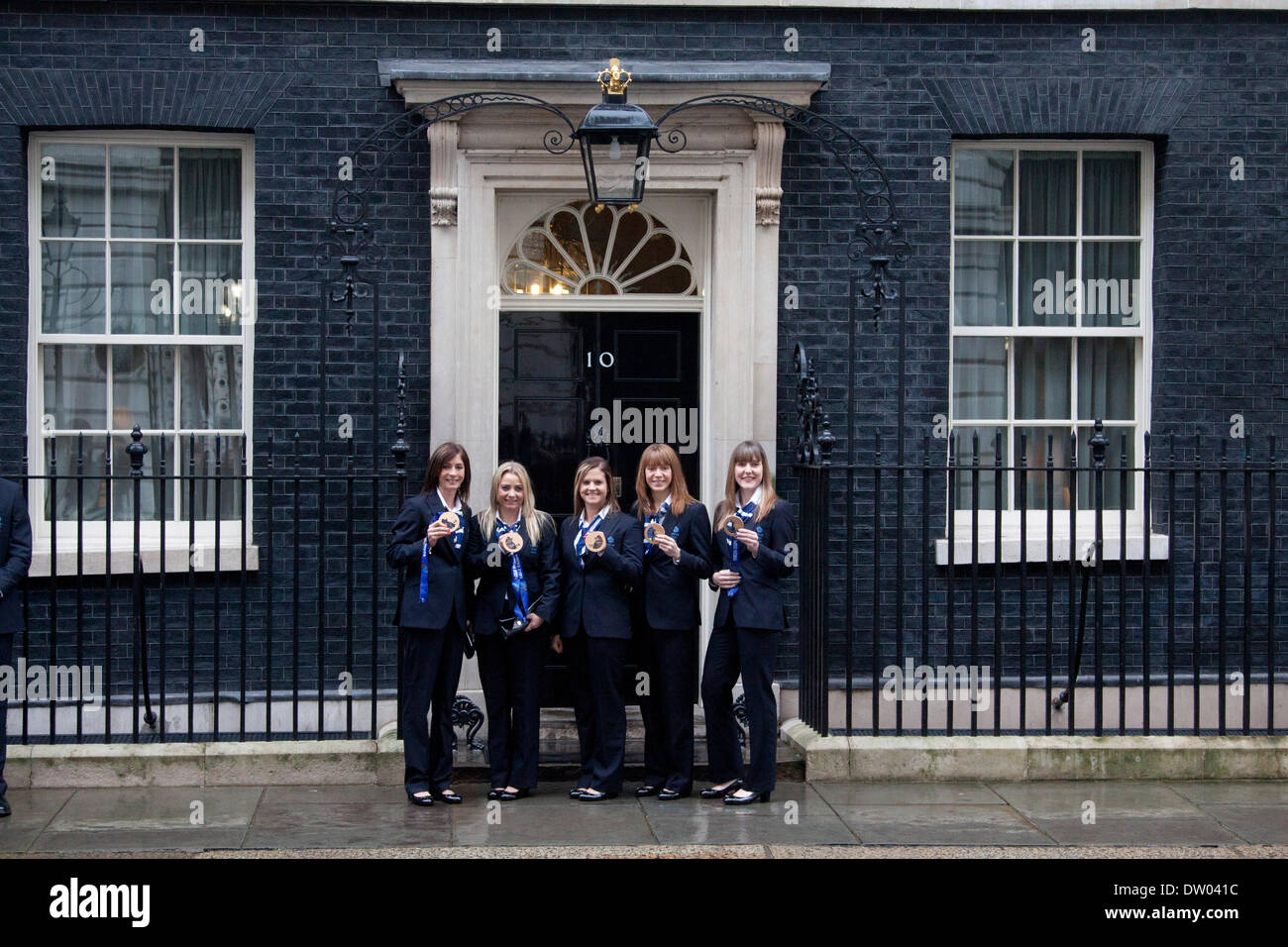 Westminster London, UK. 25th February 2014. British Women's Curling team bronze medalists, Eve Muirhead, Anna Sloan, Vicki Adams, Claire Hamilton and Lauren Gray pose with their bronze medal as British Olympic athletes and medalists from the 2014 Winter Olympic games in Sochi are honoured in a reception hosted by Prime Minister David Cameron at 10 Downing Street Credit:  amer ghazzal/Alamy Live News Stock Photo