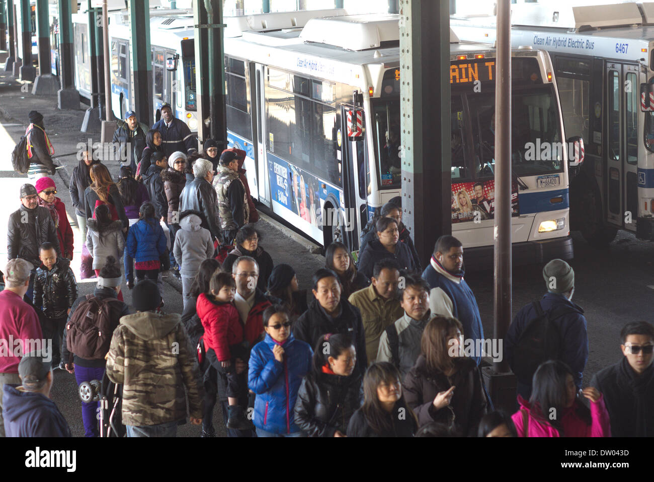 Subway riders scramble to board shuttle buses outside of the Mets-Willets Point station in New York Stock Photo