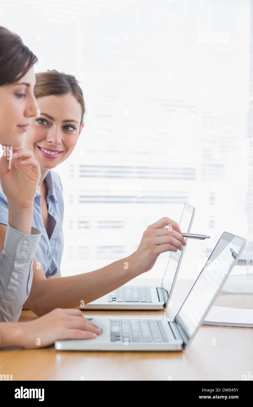 Young businesswomen working on their laptops Stock Photo - Alamy