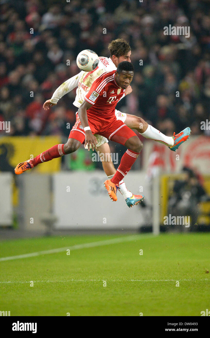 Two players jumping to head a ball, Martin Harnik, VfB Stuttgart, at the back, vs David Alaba, FC Bavaria Munich, at the front Stock Photo