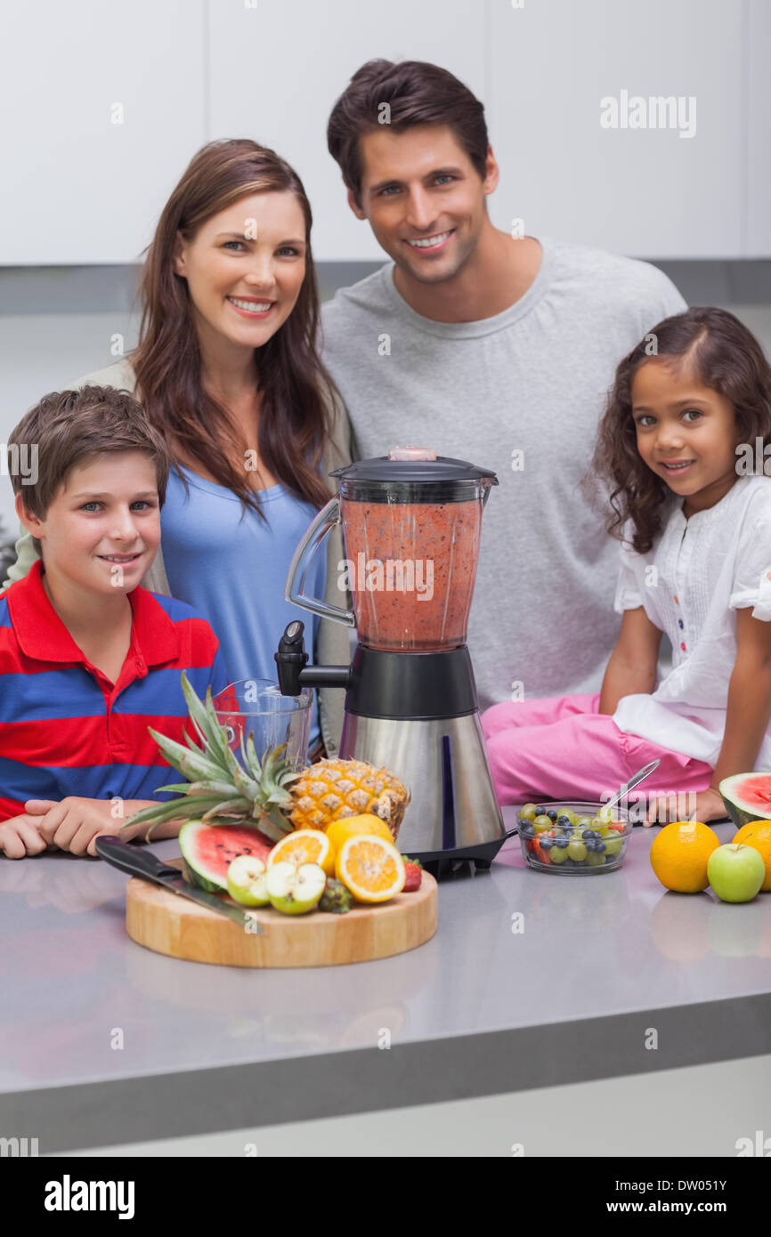 Smiling family using a blender together Stock Photo Alamy