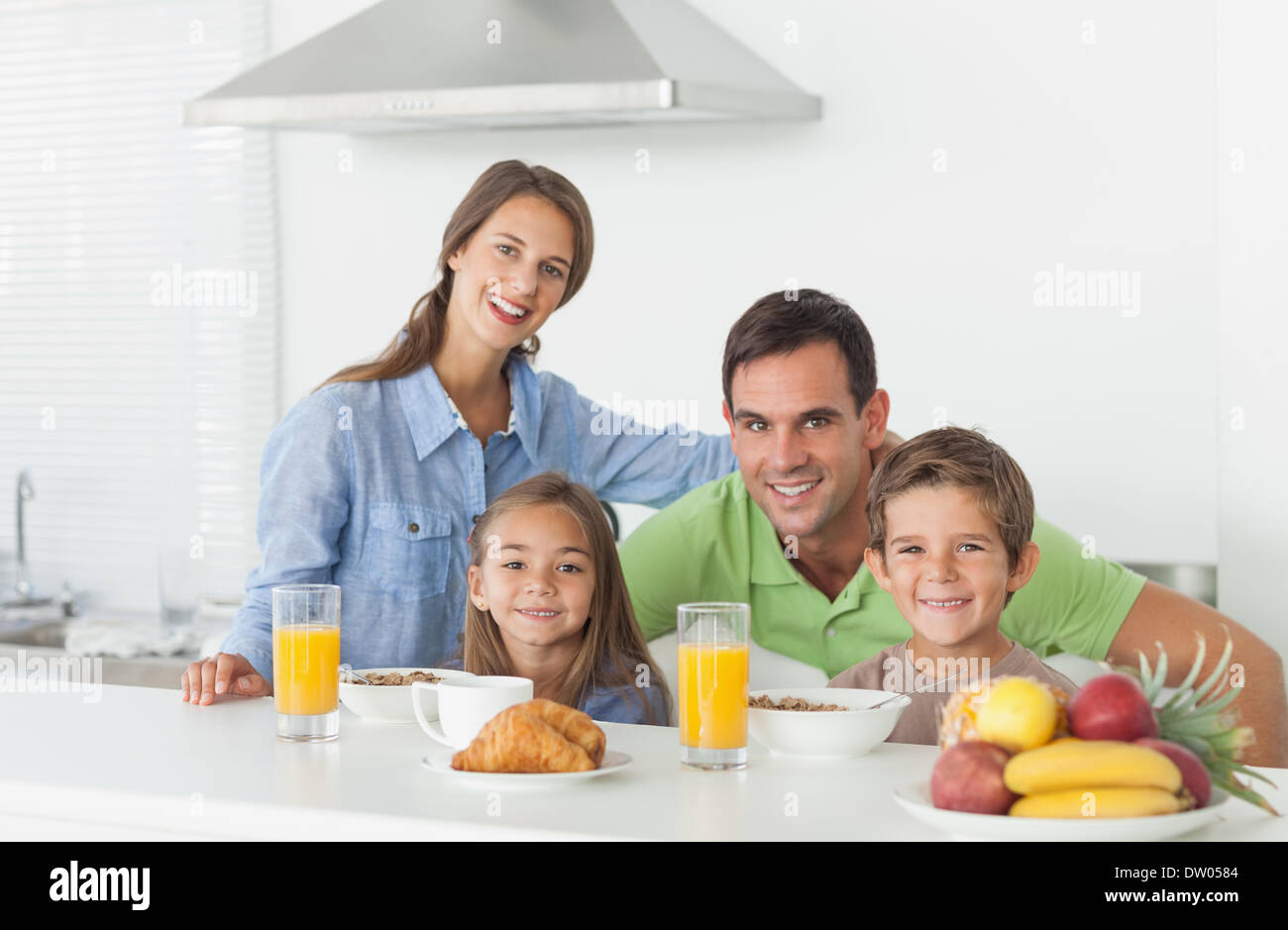 Portrait of cute family having breakfast Stock Photo - Alamy