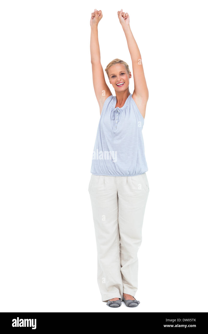 Excited woman standing with arms raised Stock Photo