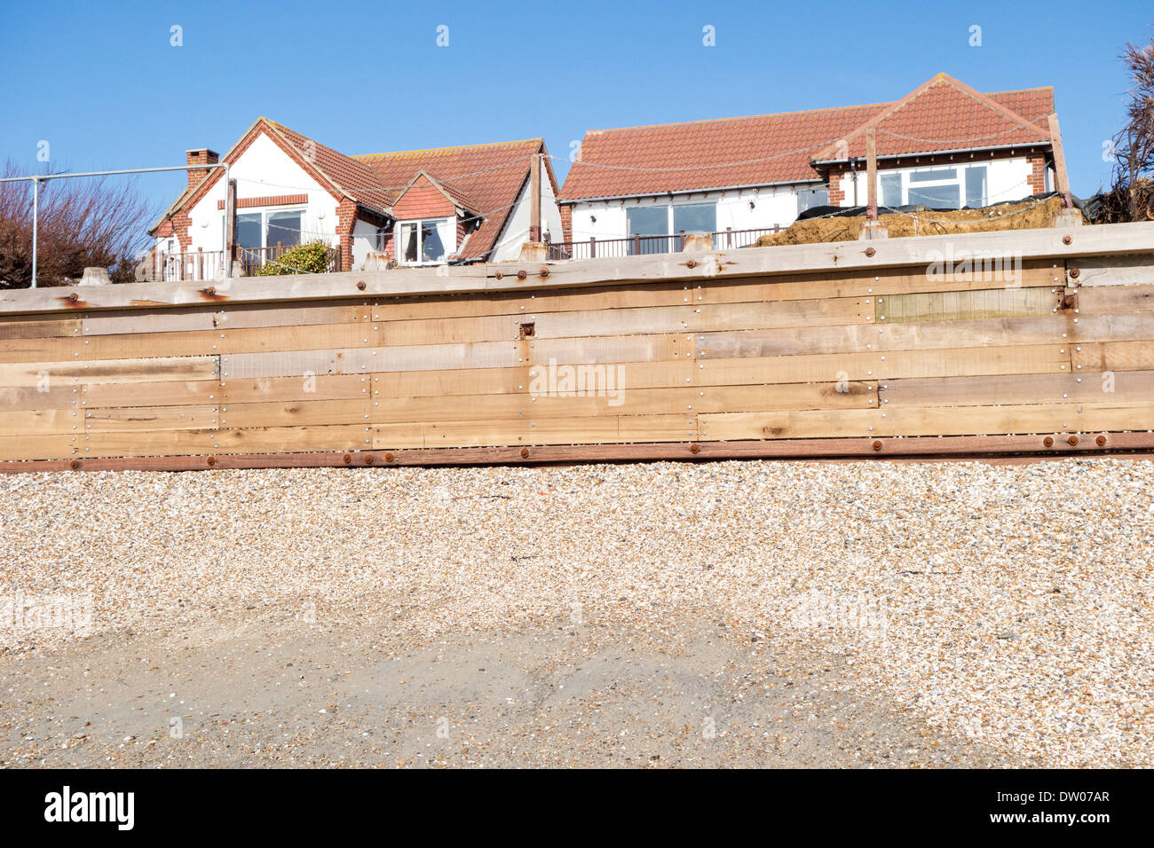 England, West Sussex, West Wittering. A newly installed timber seawall forms part of the coastal flood defence system Stock Photo