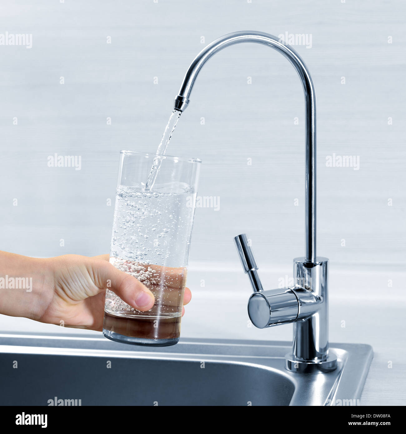 Filling glass of water in hand from kitchen faucet Stock Photo Alamy