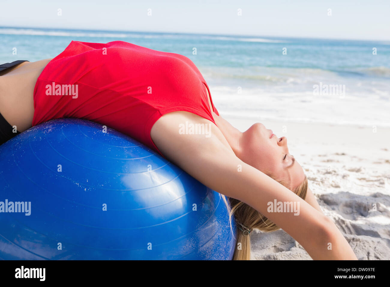 Fit blonde stretching back on exercise ball Stock Photo - Alamy