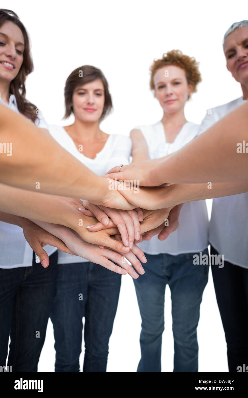 Relaxed models joining hands in a circle Stock Photo