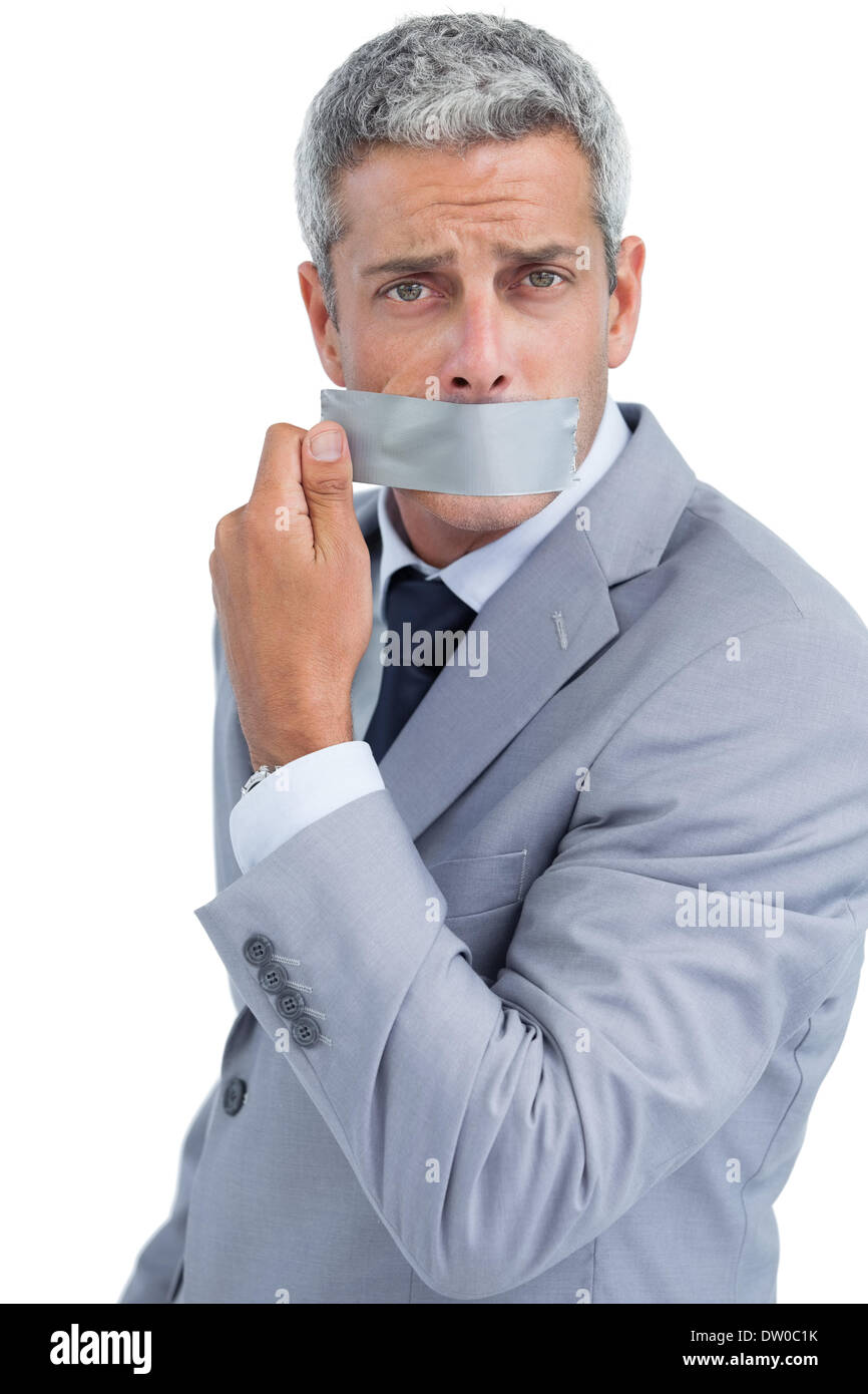 Businessman taking off duct tape on mouth Stock Photo Alamy