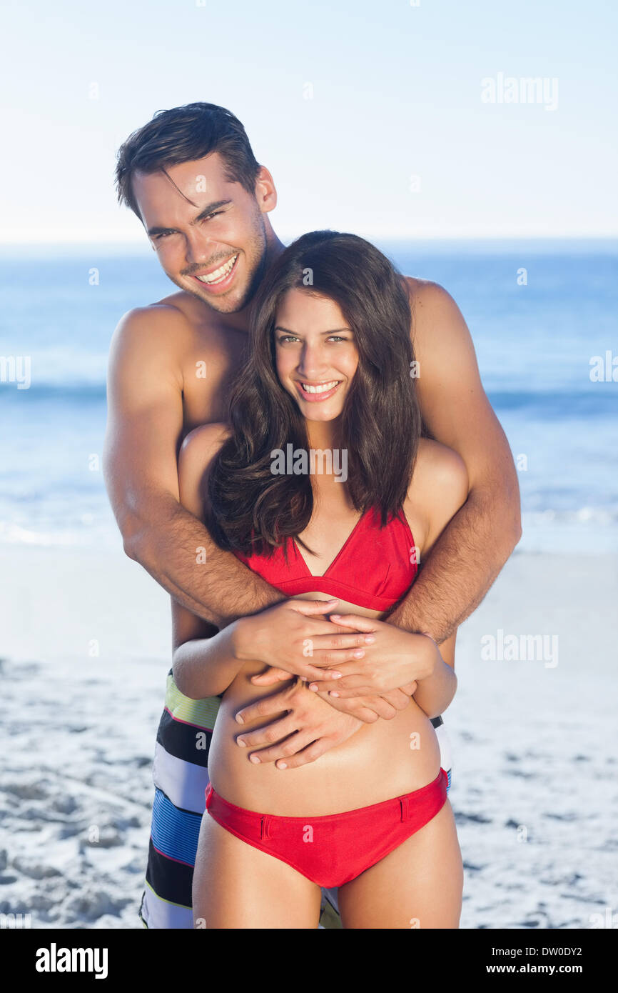Happy couple in swimsuit hugging Stock Photo - Alamy